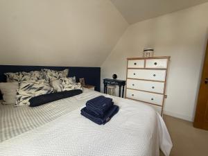a bedroom with a bed with a suitcase on it at Silsoe Cottage B&B in Silsoe