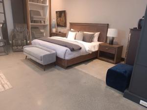 a bedroom with a large bed and a chair at Departamento en Cuenca de tres habitaciones in Cuenca