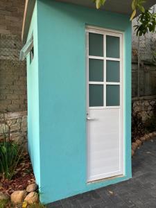 a blue building with a door and a window at Casa Los Mangales in Brisas de Zicatela