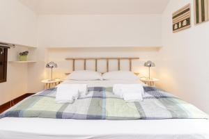 a bedroom with a bed with two night stands at Il camino felice - 201 by Houset in Monza