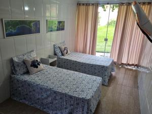 Postel nebo postele na pokoji v ubytování Espaço Verde Hospedagem