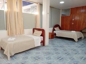 Postel nebo postele na pokoji v ubytování Hostal Insular