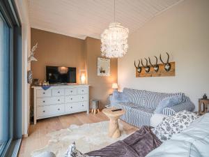 a living room with a couch and a tv at Tauernhaus Madelief in Piesendorf