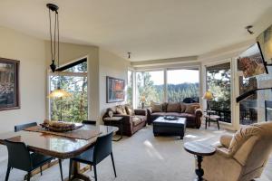 a living room filled with furniture and a table at River Ridge 517A in Bend