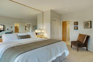 a bedroom with a large bed and a chair at River Ridge 517A in Bend +28 photos