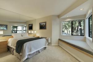 a bedroom with a large bed and windows at River Ridge 517AB in Bend +35 photos