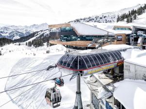 a ski lift in the snow next to a building at Mountain View Loft Bergkristall in Kaltenbach