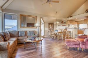a living room with a couch and a table at River Ridge 421A - Meredith Lodging in Bend