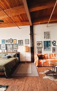 a bedroom with a bed and a couch at 420 Friendly BOHO Loft Downtown KING suite FREE parking in Detroit