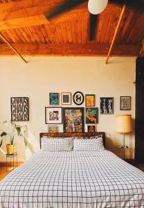 a bedroom with a large bed and pictures on the wall at 420 Friendly BOHO Loft Downtown KING suite FREE parking in Detroit +13 photos