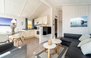 a living room with a couch and a table at Friedrichskoog-Deichblick 16 in Friedrichskoog