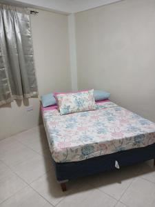 a small bed in a small room with a pillow at J's vacation home in Wallhouse