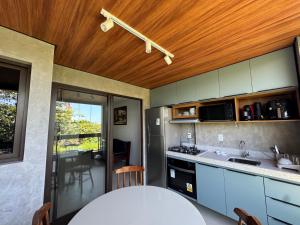 a kitchen with blue cabinets and a counter top at Flat Garden Frances in Marechal Deodoro