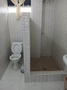 a bathroom with a shower with a toilet and a sink at J's vacation home in Wallhouse +5 photos