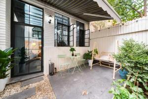 eine Terrasse mit einem Sofa und einem Tisch und Fenstern in der Unterkunft 柃居 B&B - Huaihai Middle Road Branch in Shanghai