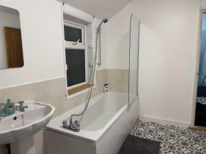 ein Badezimmer mit Badewanne, Waschbecken und Dusche in der Unterkunft The fulfilling dover retreat in Dover + 1 Foto