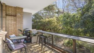 a balcony with a table and chairs and a view at Flynns Beach Seascape in Port Macquarie
