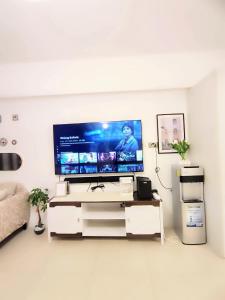 a living room with a large flat screen tv at aeon condon studio unit in Davao City