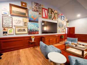 a living room with a large wall of art at The Sienna Hunter Valley in Luskintyre