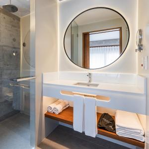 a bathroom with a sink and a mirror at Juquehy Praia Hotel in Juquei
