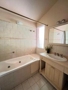 Rocco Housse في لوس هورنيلوس: حمام مزود بحوض استحمام ومغسلة ومرآة