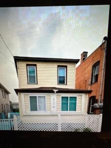 a house with a white fence in front of it at North Central Atlantic City in Atlantic City