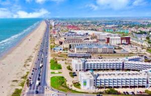 an aerial view of a beach with buildings and the ocean at Blue Bliss Beachfront Condo in Galveston
