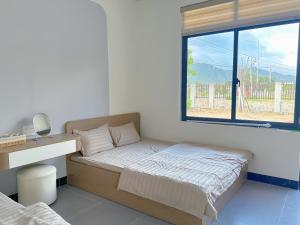 Ένα ή περισσότερα κρεβάτια σε δωμάτιο στο Chou Homstay