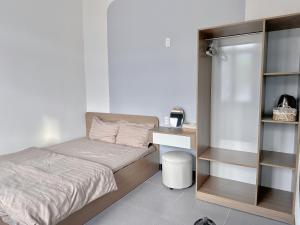 Ένα ή περισσότερα κρεβάτια σε δωμάτιο στο Chou Homstay