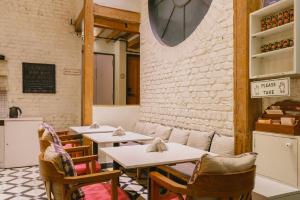 a restaurant with tables and chairs and a brick wall at Abode Bombay in Mumbai