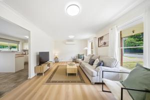 a living room with a couch and a table at Bellbird Willow Hunter Escape by Nature & Winery in Bellbird