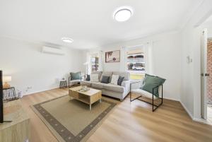 a living room with a couch and a table at Bellbird Willow Hunter Escape by Nature & Winery in Bellbird