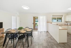 a kitchen and dining room with a table and chairs at Bellbird Willow Hunter Escape by Nature & Winery in Bellbird