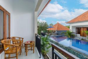 a balcony of a house with a swimming pool at Memela Bungalow in Nusa Penida