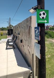 a wall with a bench and a soccer ball on it at La Soñada in San Miguel del Monte +4 photos