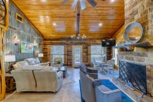 a living room with couches and a stone fireplace at Frio Hills Hideaway in Leakey