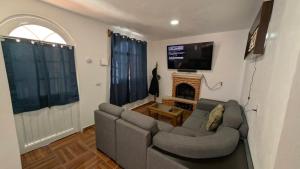 ein Wohnzimmer mit Sofa und Kamin in der Unterkunft Casa Rancho El Capulín en Grutas de Tolantongo 