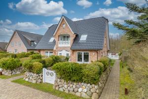 a brick house with a gray roof at Godewind App 5 in Westerland