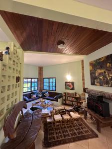 a living room with a couch and a fireplace at Casa Paraíso do Ribeirão in Lençóis