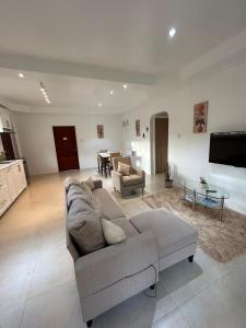 a living room with a couch and a table at Agape Suites-Room 4- 1st Floor in Soufrière
