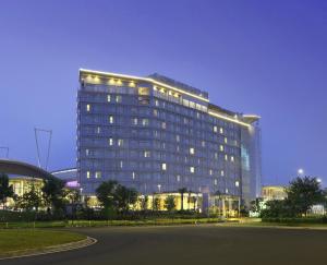a large building with lights on it at night at Hotel Santika Premiere ICE - BSD City in Serpong