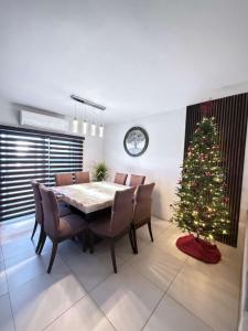 a dining room with a table and a christmas tree at Casona Álamo in La Coyotera