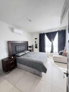 a bedroom with a bed and a large window at Casona Álamo in La Coyotera