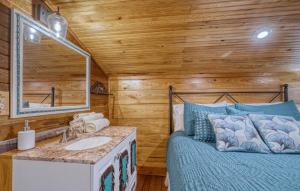 a bathroom with a bed and a sink in a room at Frio Hills Hideaway in Leakey +33 photos