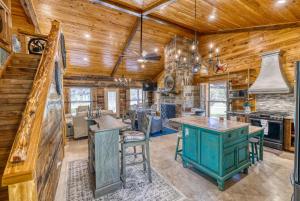 a kitchen with wooden walls and wooden ceiling at Frio Hills Hideaway in Leakey