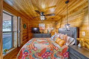 a bedroom with a bed and a ceiling fan at Frio Hills Hideaway in Leakey