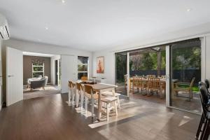 a kitchen and dining room with a table and chairs at Whakata on McBride in Queenstown +19 photos