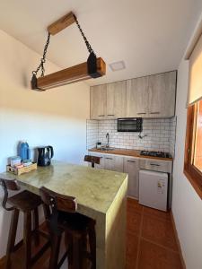 a kitchen with a large wooden table and chairs at Cabañas La Sonrisa in Puerto San Julián +5 photos