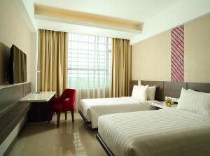 Un pat sau paturi într-o cameră la Hotel Santika Premiere ICE - BSD City