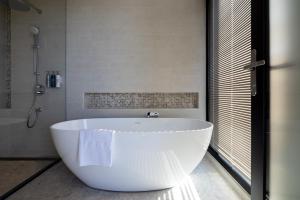 a white bath tub in a bathroom with a shower at House Residence in Magong +19 photos